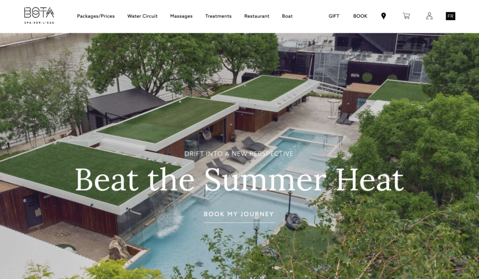 A screenshot of the Bota Bota homepage, with an aerial view of Bota Bota spa in Montreal, showcasing outdoor pools, wooden deck areas with loungers, and lush greenery along the waterfront, with the slogan 'Beat the Summer Heat' displayed prominently.